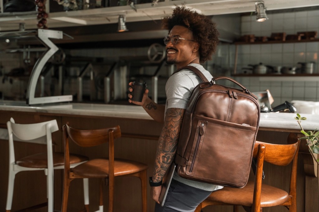 Homem com mochila de couro para notebook 17 polegadas Pelli Brasil em viagem de trabalho
