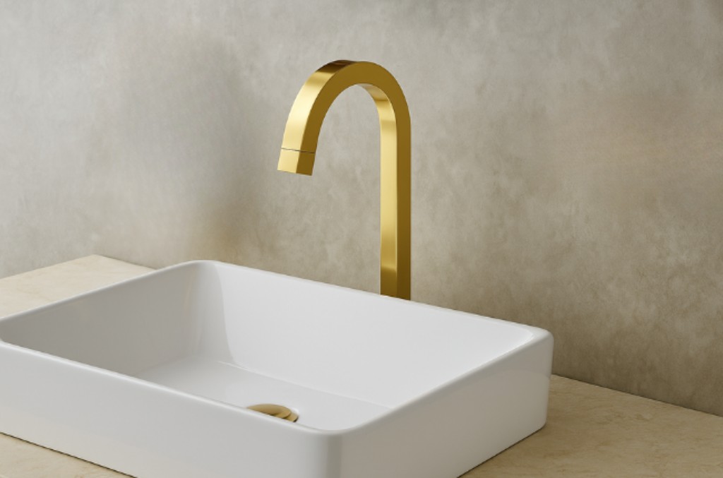 Torneira modelo easy dourada instalada na bancada junto a uma cuba de sobrepor.