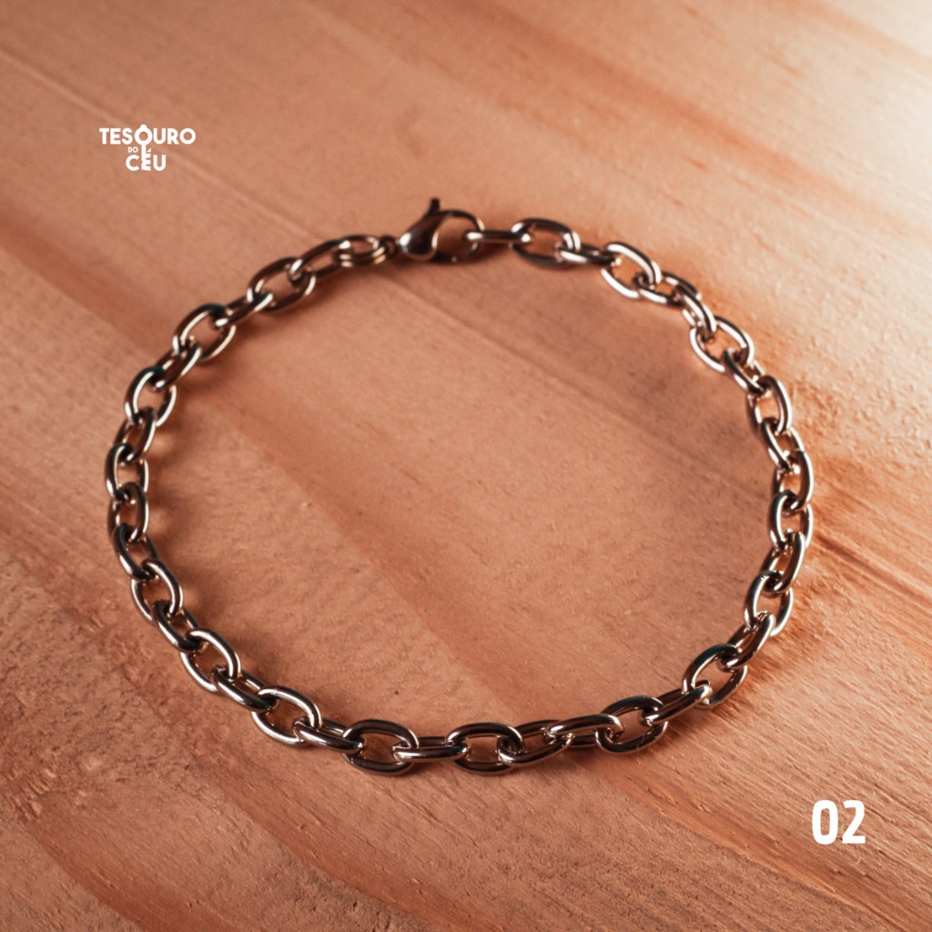 Pulseira de consagra&ccedil;&atilde;o Tesouro do C&eacute;u modelo 02, fotografada sobre madeira.