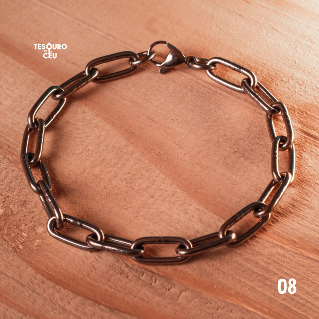 Pulseira de consagra&ccedil;&atilde;o Tesouro do C&eacute;u modelo 08, fotografada sobre madeira.