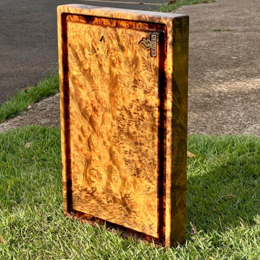 T&aacute;bua de churrasco Kroven em madeira nobre tipo Burl, apresentando desenhos org&acirc;nicos &uacute;nicos e fibras densas de madeira maci&ccedil;a de alta resist&ecirc;ncia.