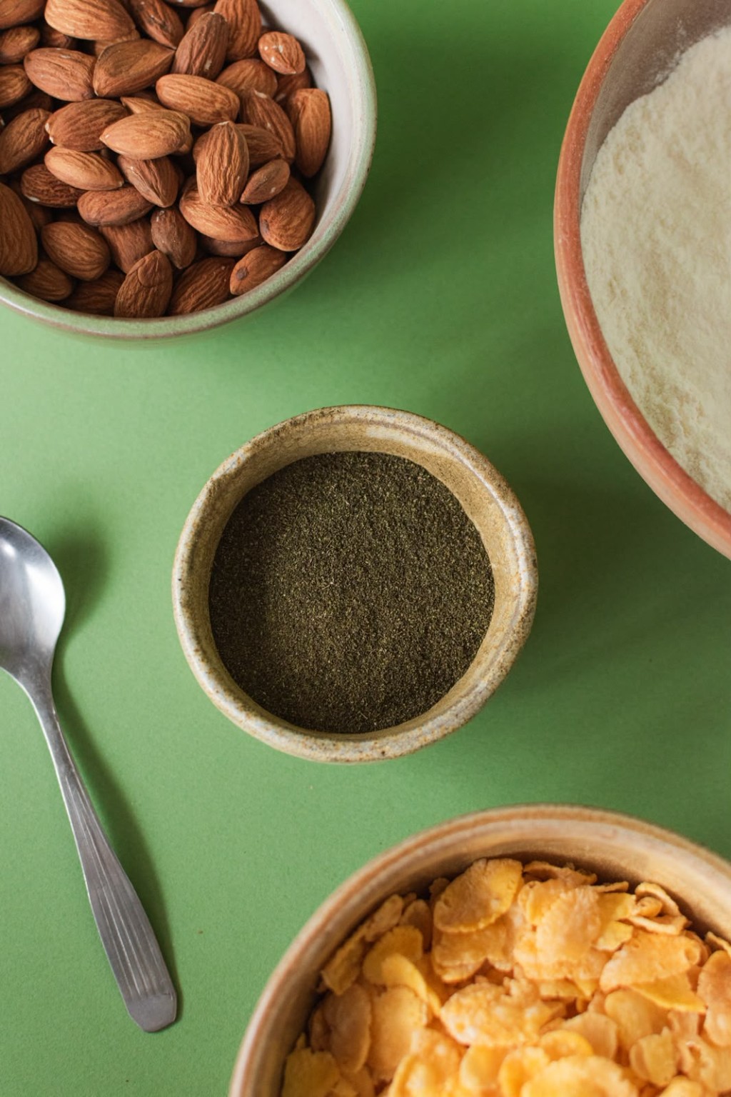 Bowl con stevia en polvo y una cuchara junto a ingredientes para cocinar