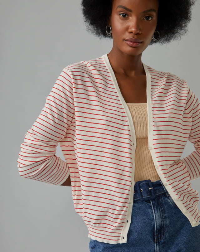 Modelo usando look com cardigan listrado vermelho